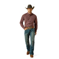 Man wearing a brown checkered shirt, blue jeans, and a cowboy hat on a white background