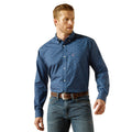 Man wearing a blue patterned shirt and jeans on a white background