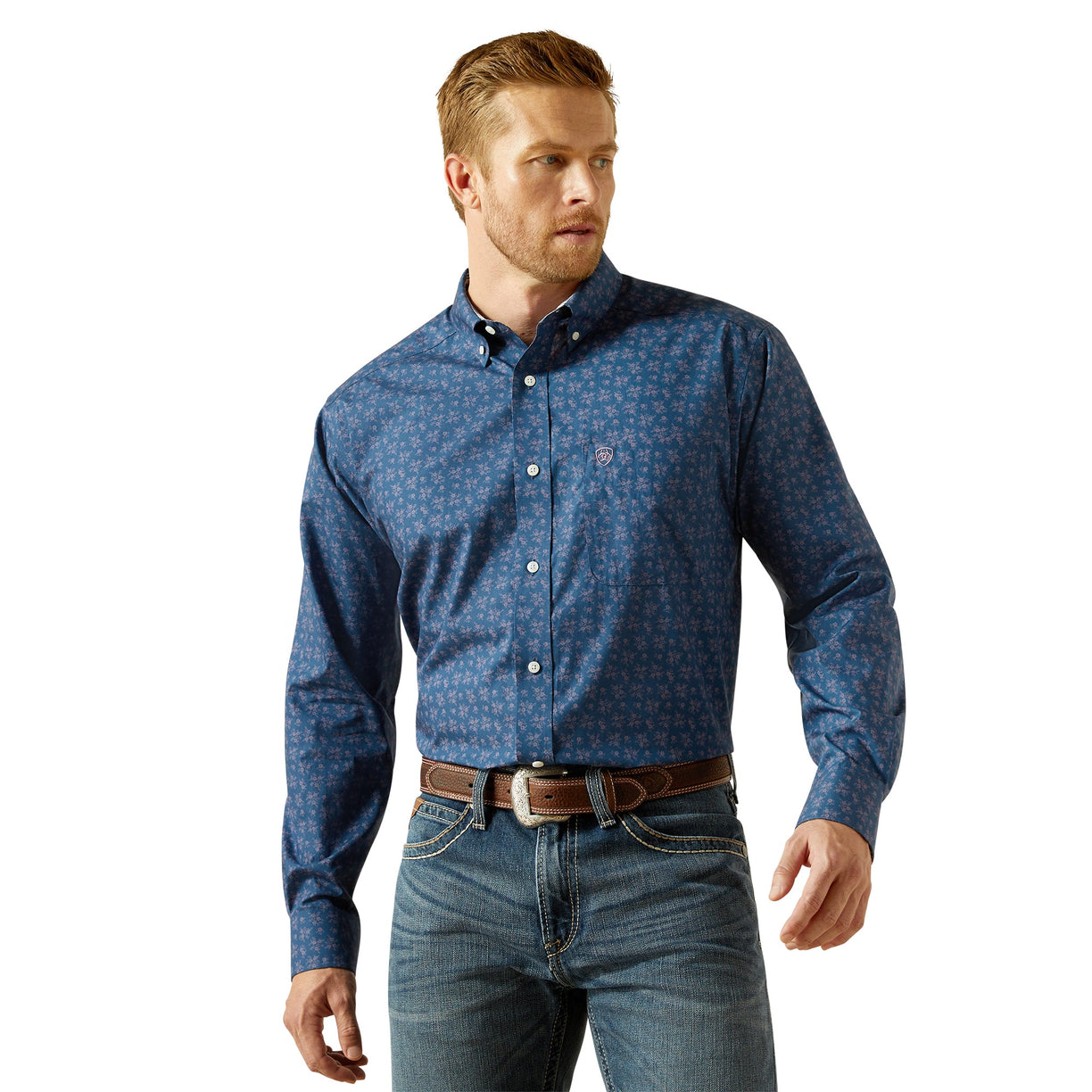Man wearing a blue patterned shirt and jeans on a white background