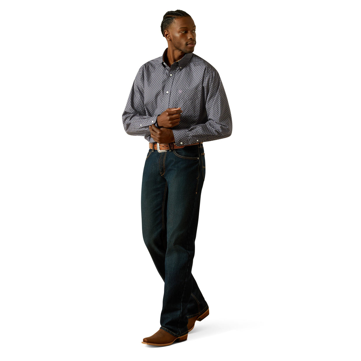 Man wearing a patterned shirt and dark pants on a white background