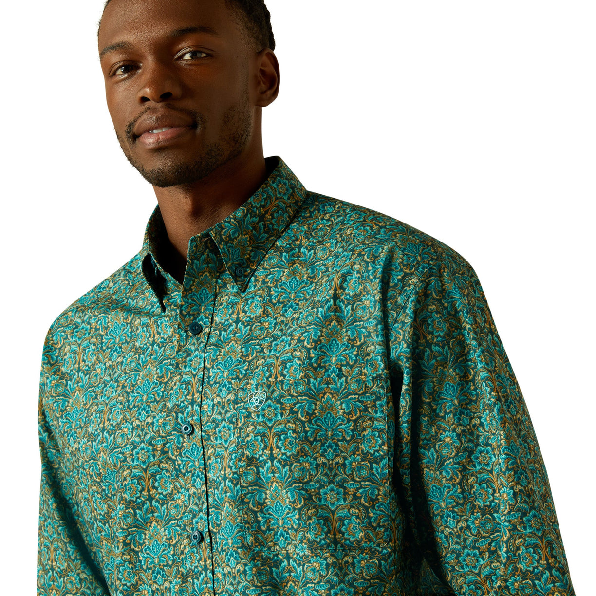 Man wearing a teal patterned shirt on a white background