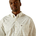 Man wearing a patterned shirt on a white background