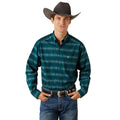 Man wearing a teal patterned shirt, jeans, and a cowboy hat on a white background