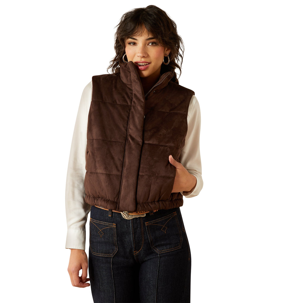 Woman wearing a brown quilted vest on a white background