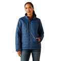 Woman wearing a blue quilted jacket on a white background