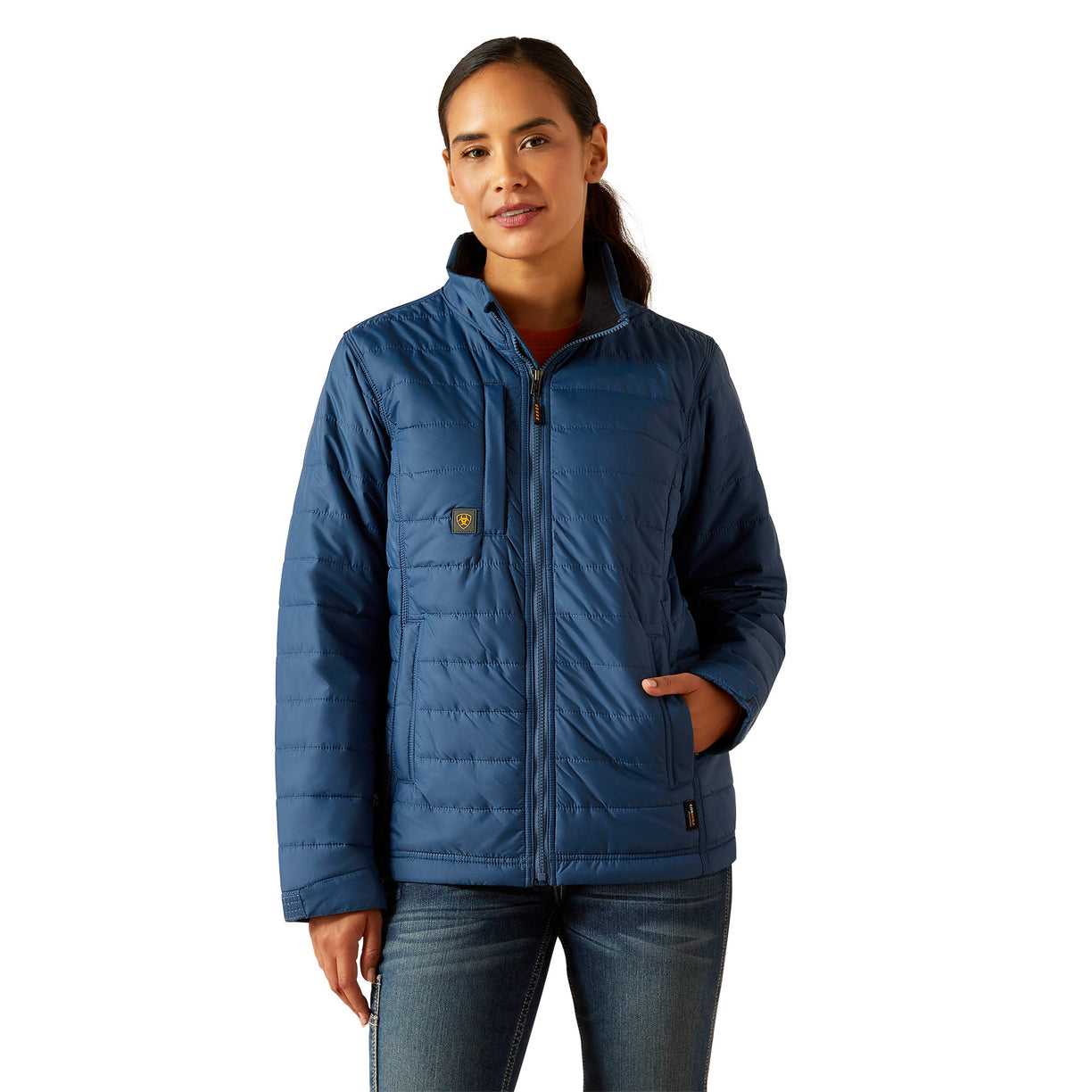 Woman wearing a blue quilted jacket on a white background