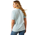 Woman wearing a light blue t-shirt and jeans on a white background
