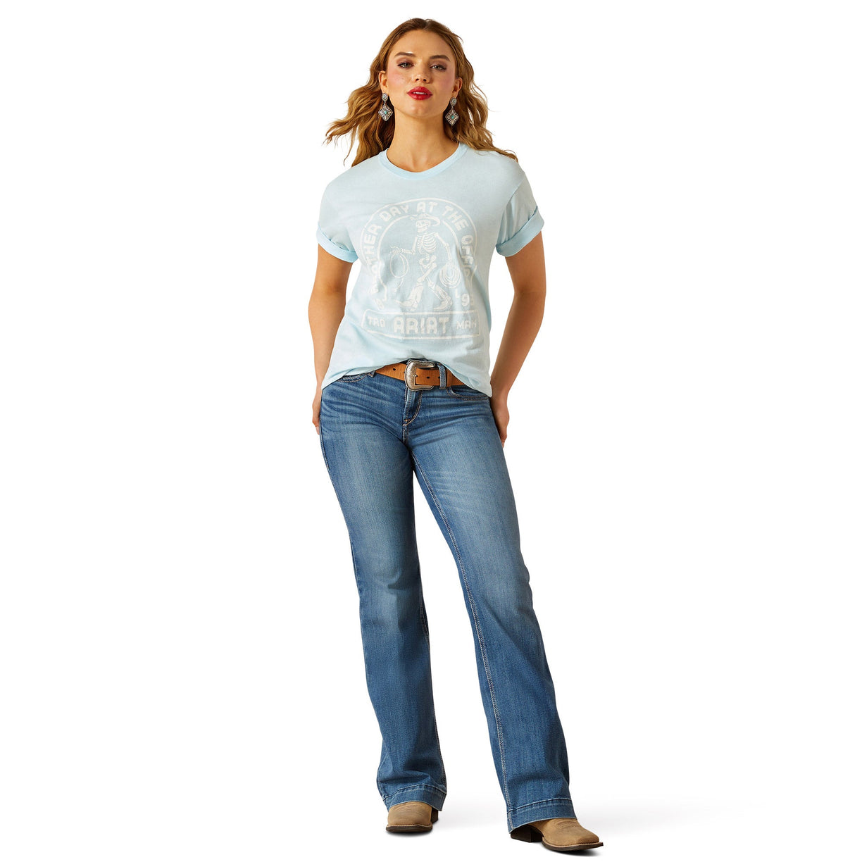Woman wearing a light blue t-shirt and blue jeans on a white background