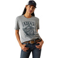 Woman wearing a gray Ariat t-shirt with a logo on a white background