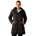 Woman wearing a black puffer coat on a white background