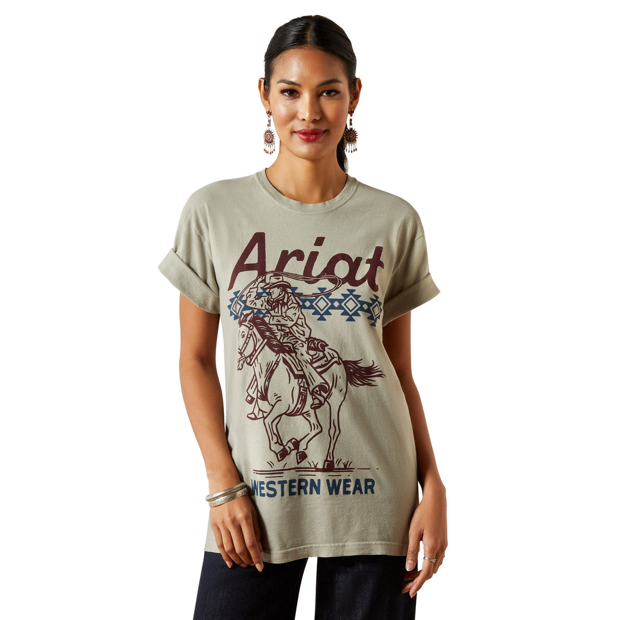 Woman wearing a beige t-shirt with 'Ariat Western Wear' graphic design on a white background