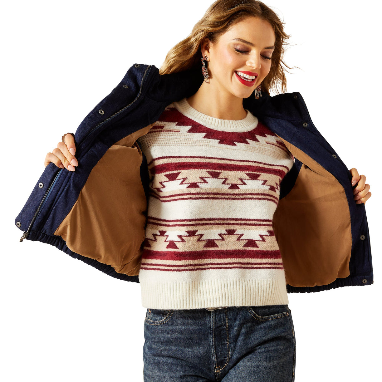 Woman wearing a patterned sweater with a navy jacket over her shoulders on a white background