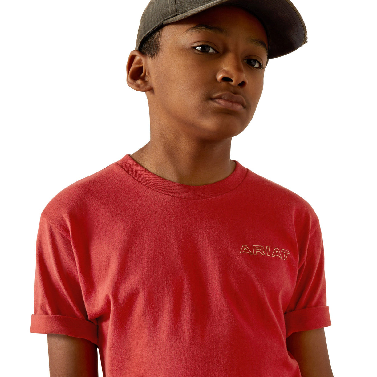 Child wearing a red Ariat t-shirt and brown cap on a white background