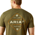Man wearing an olive green Ariat t-shirt with branding on the back.