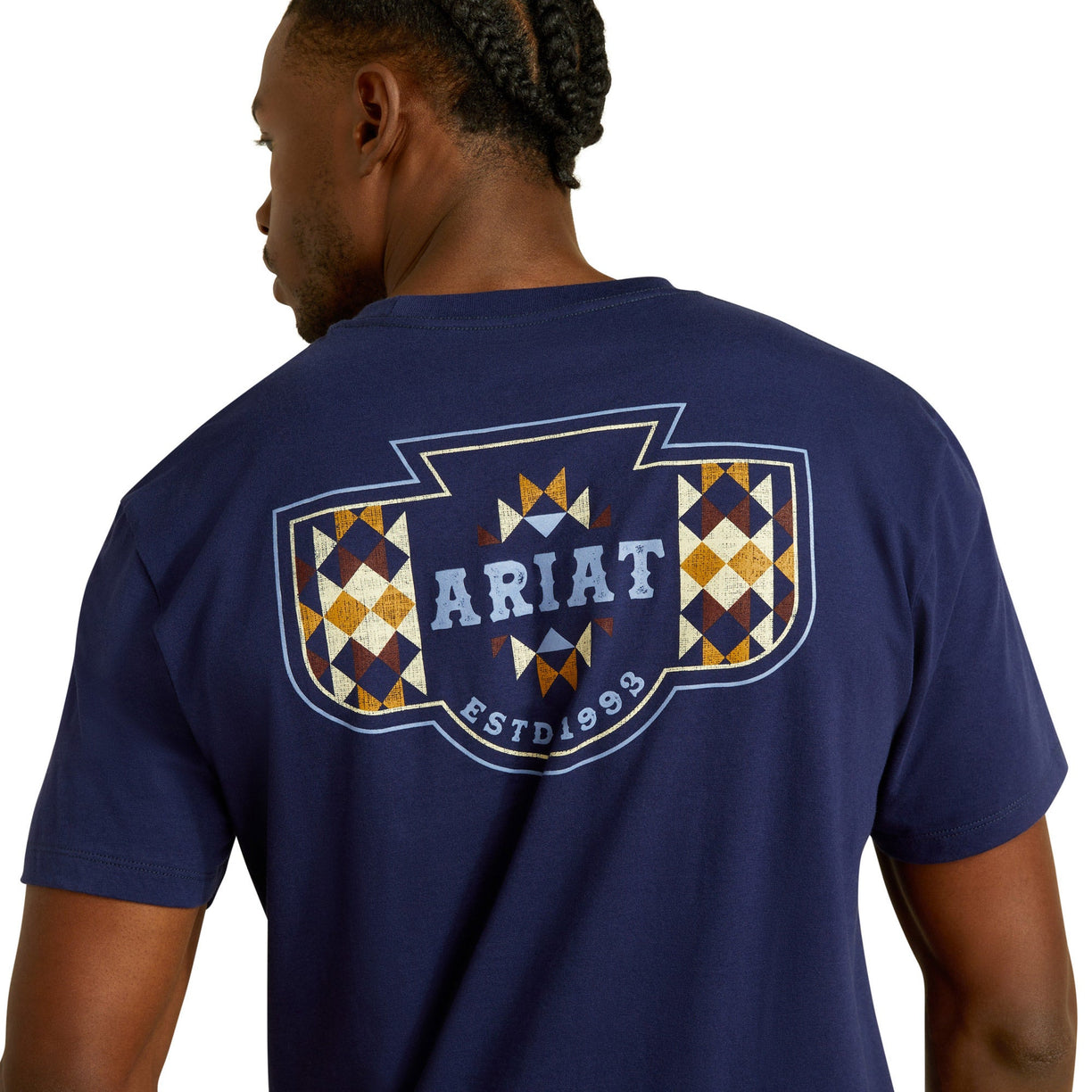 Man wearing a navy blue Ariat t-shirt with a logo on the back