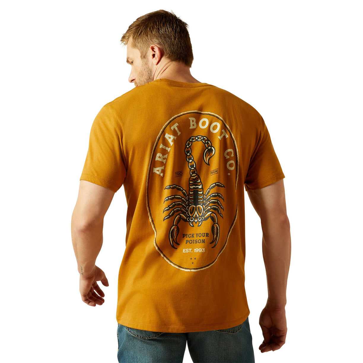 Man wearing a mustard yellow t-shirt with a scorpion logo on the back, on a white background