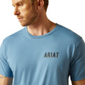 Man wearing a blue Ariat t-shirt on a plain background