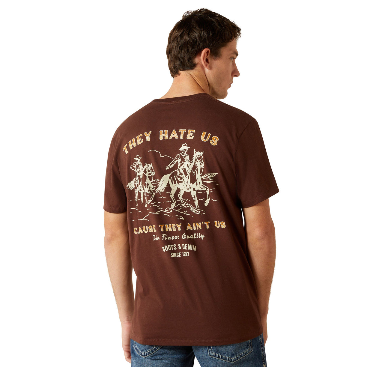 Man wearing a brown t-shirt with graphic design and text on the back, standing against a white background.