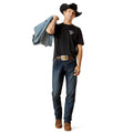 Man wearing a black t-shirt, blue jeans, and a cowboy hat holding a jacket on a white background