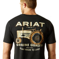 Man wearing a black t-shirt with Ariat branding and tractor graphic on the back.