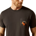 Man wearing a black t-shirt with a logo on the chest against a white background
