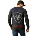 Person wearing a dark long-sleeve shirt with a logo and 'Ariat' text on the back, standing against a white background.