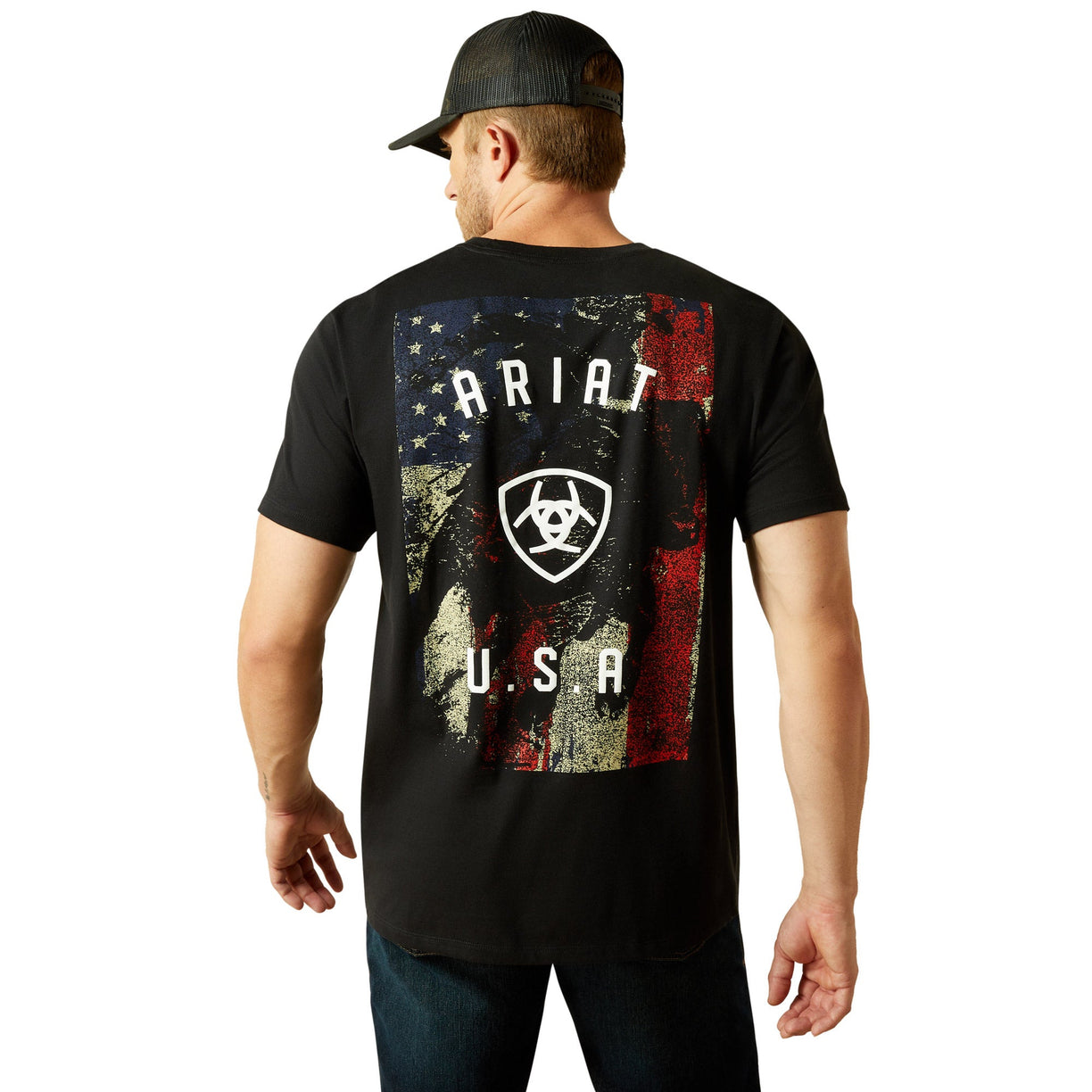 Man wearing a black t-shirt with 'Ariat U.S.A' design on the back, standing against a white background.