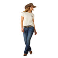Woman wearing a white t-shirt, blue jeans, and a brown cowboy hat on a white background