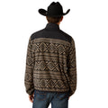 Person wearing a black and beige patterned jacket with a cowboy hat on a white background