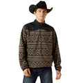 Man wearing a black and brown patterned pullover with a cowboy hat on a white background