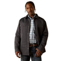 Man wearing a dark jacket over a plaid shirt on a white background