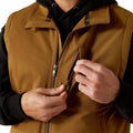 Person wearing a brown jacket with a black hood, focusing on the zipper area.