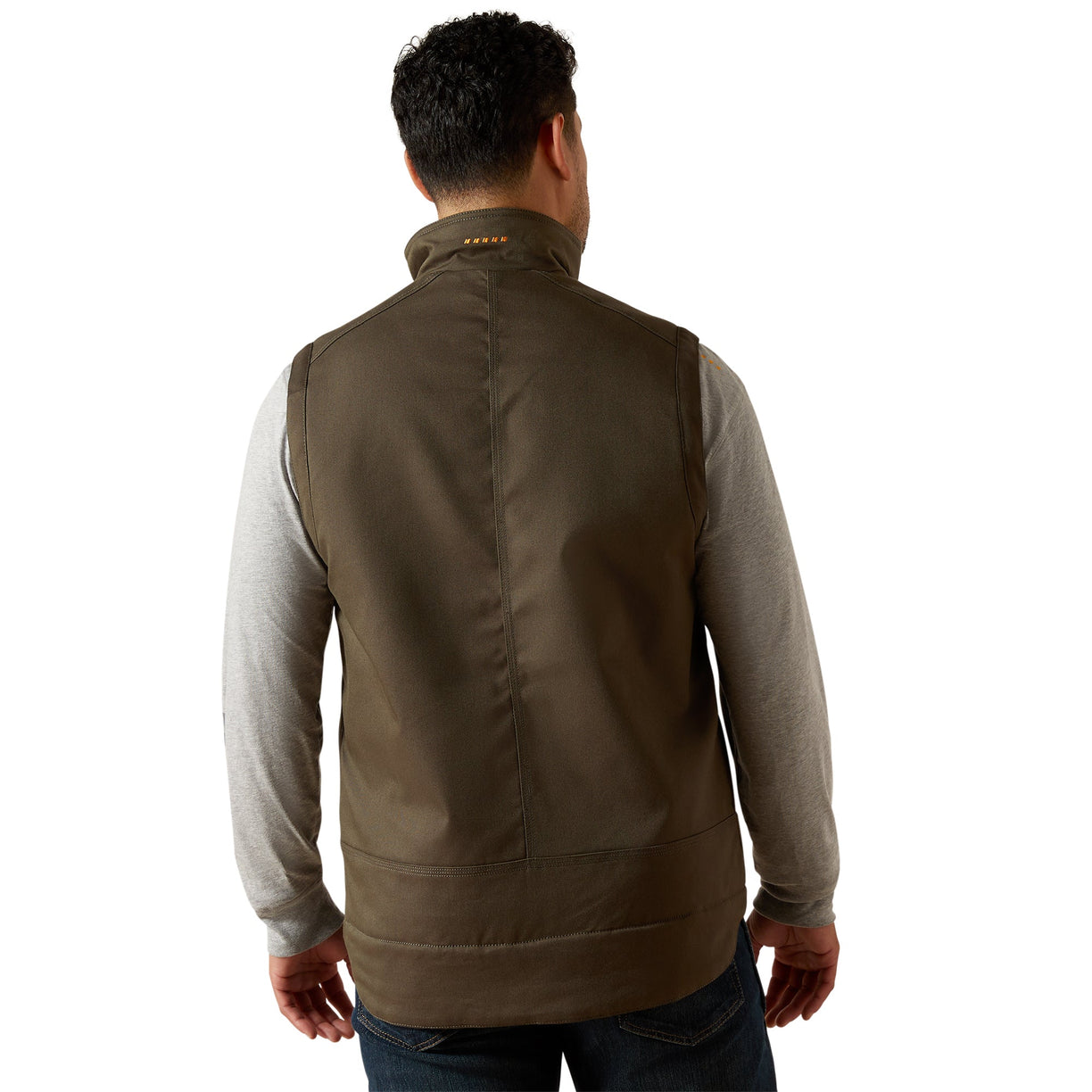 Man wearing a brown vest over a light gray shirt on a white background