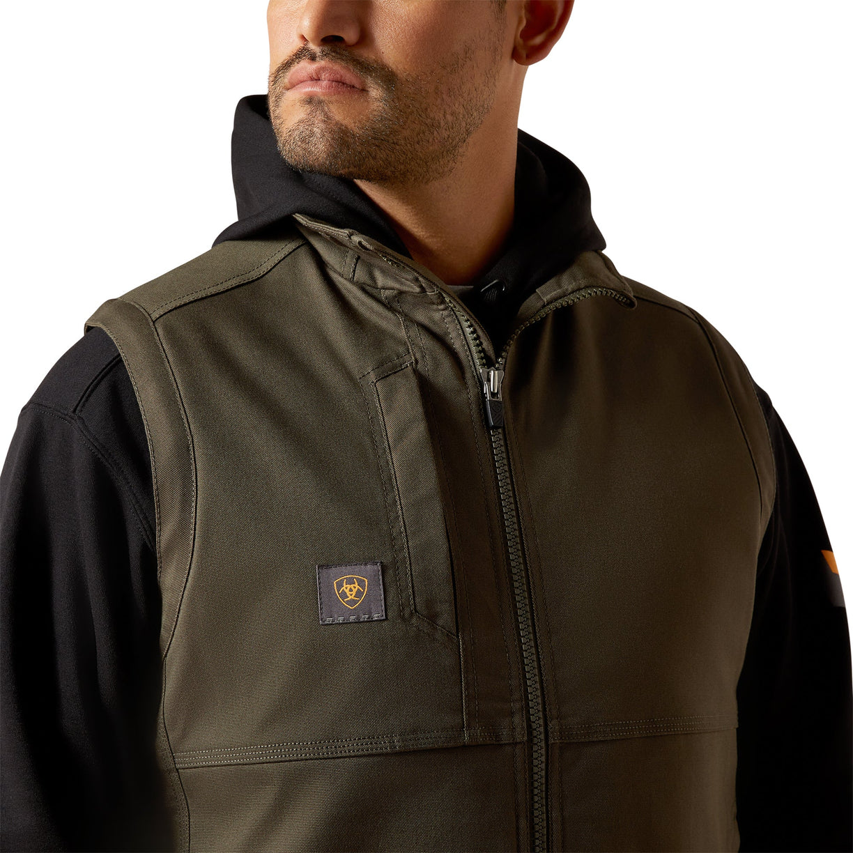Close-up of a person wearing a dark green jacket with a brand logo on a white background