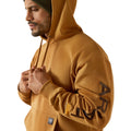 Man wearing a brown hoodie with visible branding on sleeves against a white background