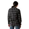 Person wearing a black and gray plaid shirt on a white background
