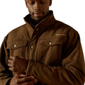 Man wearing a brown jacket with a brand logo on a white background