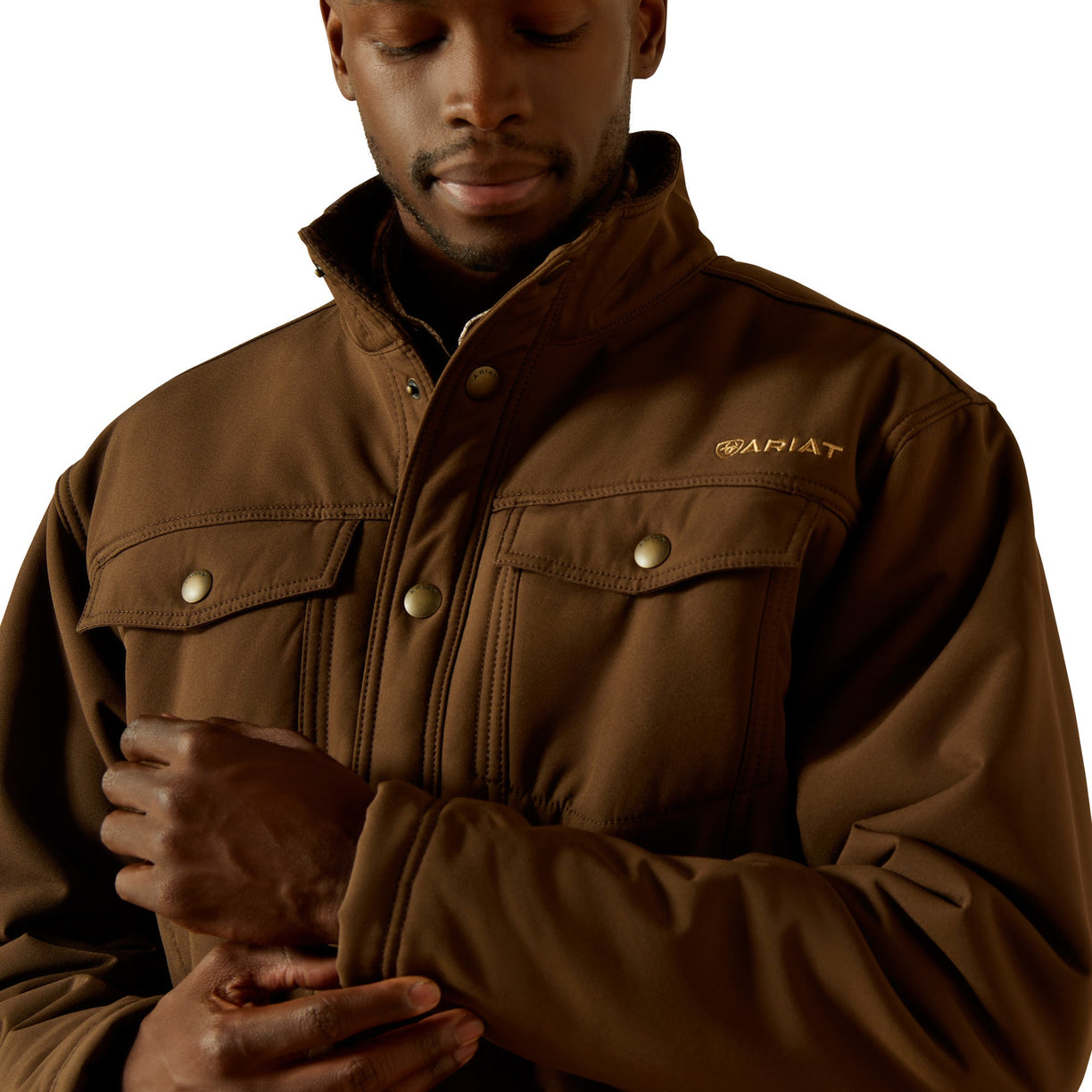 Man wearing a brown jacket with a brand logo on a white background