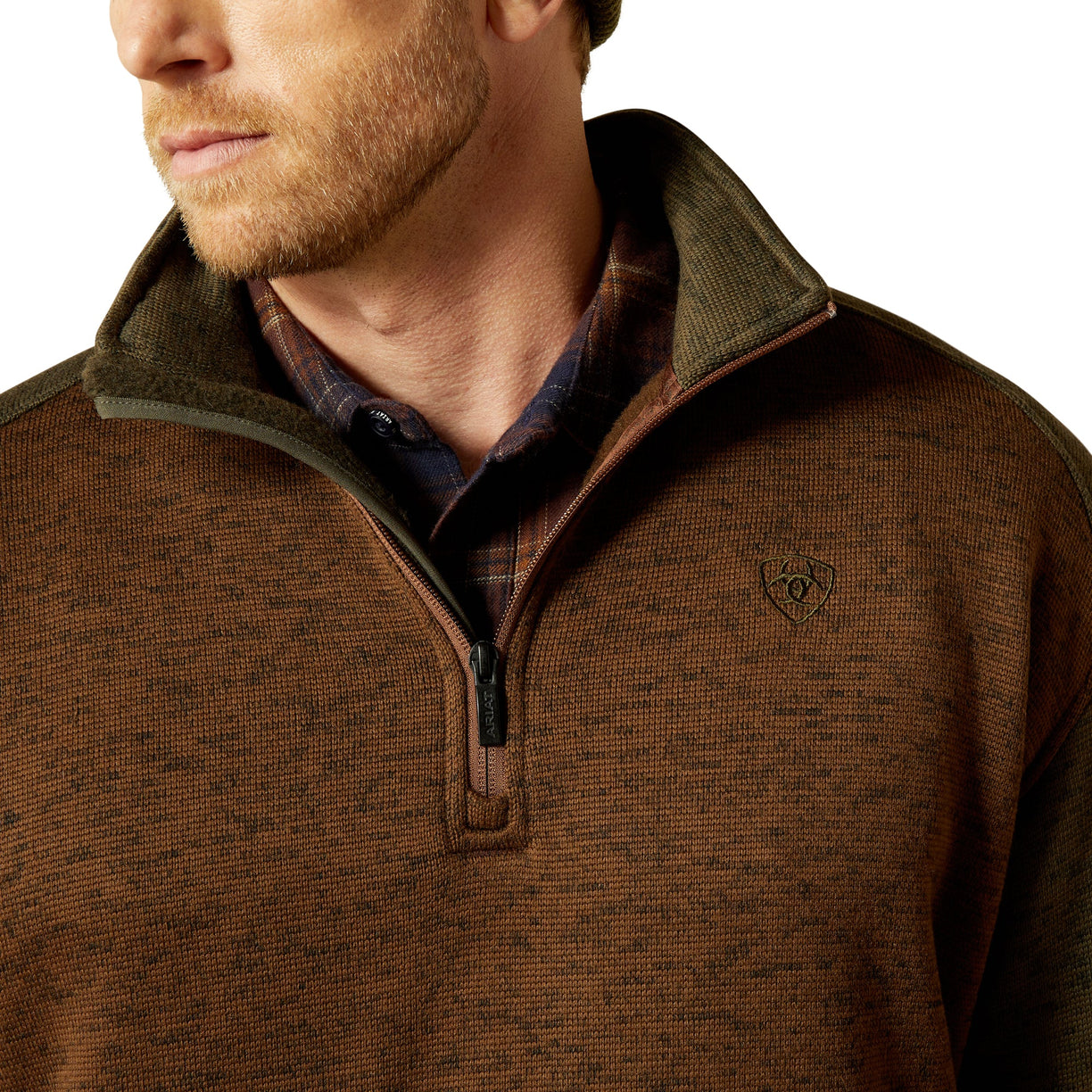 Close-up of a brown pullover with a collar and logo on a white background