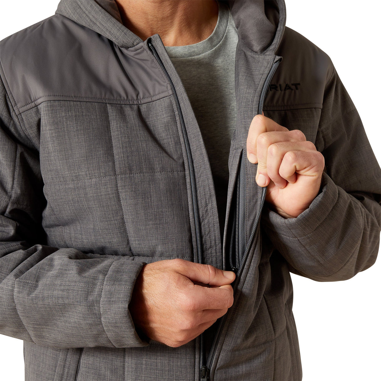 Person wearing a gray jacket with a hood on a white background