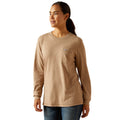 Woman wearing a beige long-sleeve shirt on a white background