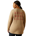 Person wearing a tan long-sleeve shirt with 'Ariat Work Est. 1999' text on the back.