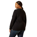 Person wearing a black long-sleeve shirt and blue jeans on a white background