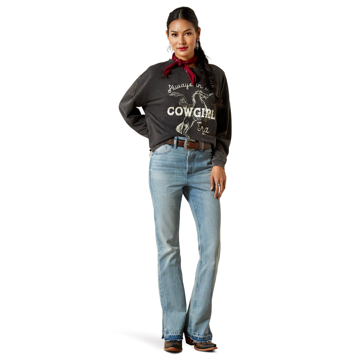 Woman wearing a black shirt with 'Always be a Cowgirl' text and blue jeans on a white background
