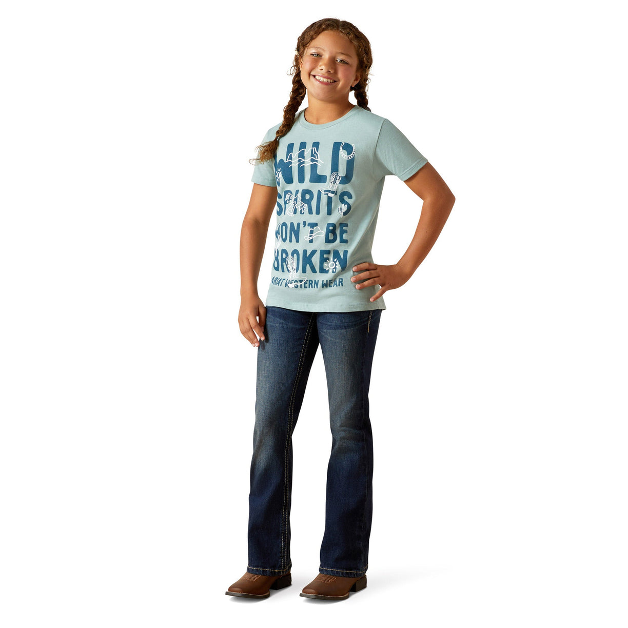 Young girl wearing a light blue t-shirt with text and dark jeans on a white background