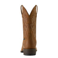 Brown cowboy boot with intricate embossing on a white background