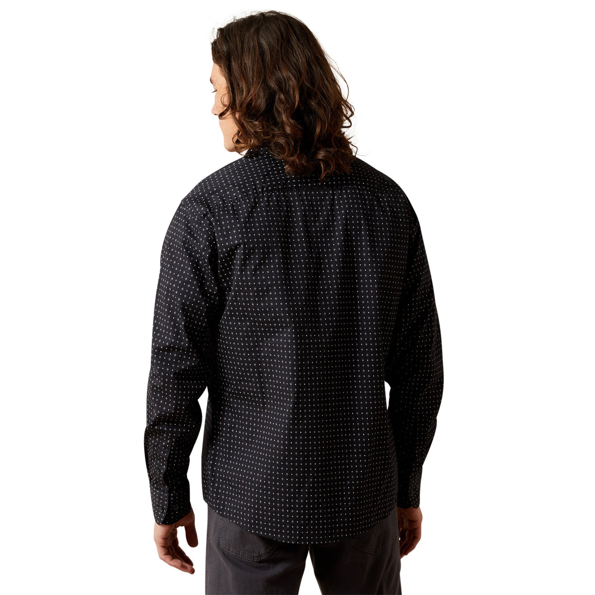 Person wearing a black patterned shirt on a white background