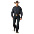 Man wearing a plaid shirt, jeans, and a cowboy hat on a white background