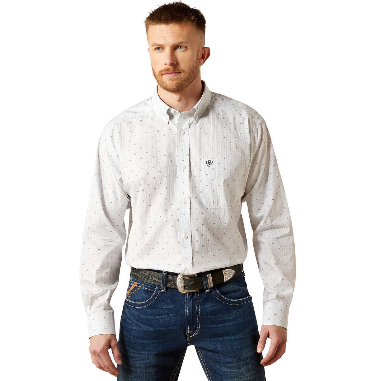 Man wearing a light gray patterned shirt and blue jeans on a white background