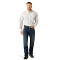 Man wearing a light-colored button-up shirt and dark jeans on a white background
